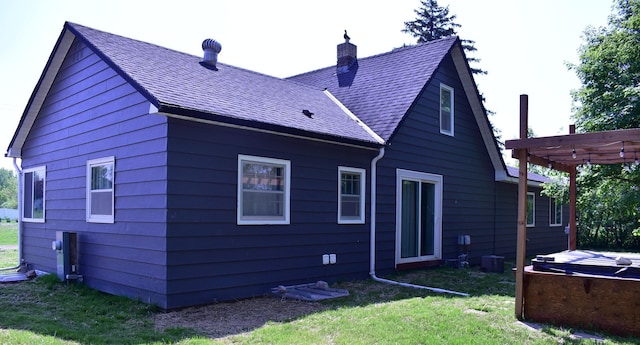 1706 Alcott Ave, Buse Twp, MN 56537 - rear view of property featuring a chimney, a lawn, roof with shingles, a covered hot tub, and a pergola