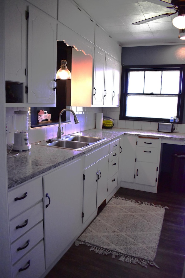 1706 Alcott Ave, Buse Twp, MN 56537 - kitchen with a sink, wood finished floors, white cabinets, light countertops, and decorative backsplash