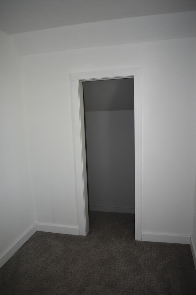 1706 Alcott Ave, Buse Twp, MN 56537 - empty room featuring dark colored carpet and baseboards