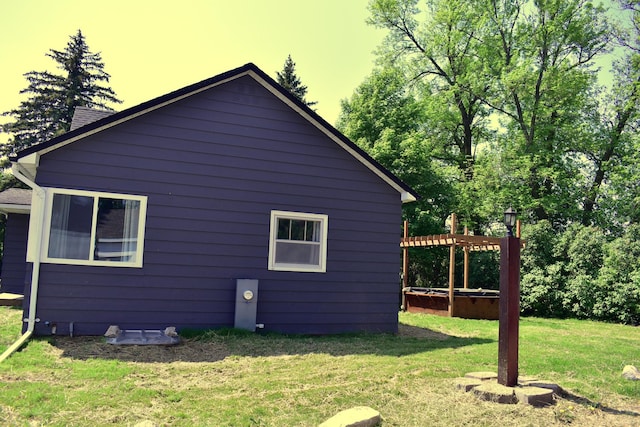 1706 Alcott Ave, Buse Twp, MN 56537 - property exterior at dusk with a pergola and a lawn