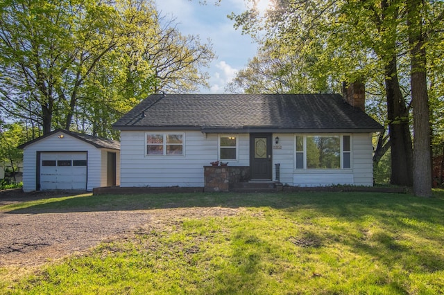 504 Wisconsin Ave N, Frederic, WI 54837 - view of front of home featuring driveway, a chimney, an outdoor structure, a front lawn, and a detached garage