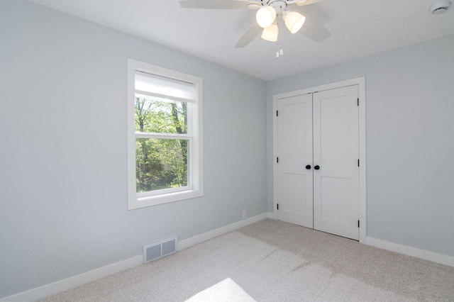504 Wisconsin Ave N, Frederic, WI 54837 - unfurnished bedroom featuring carpet, a closet, baseboards, and ceiling fan