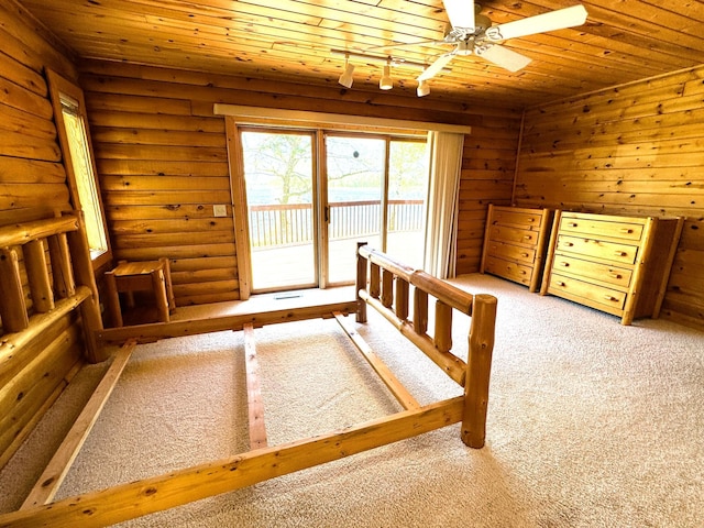 35918 410th Ave SE, Queen Twp, MN 56542 - unfurnished bedroom with wood ceiling, carpet floors, access to exterior, and log walls