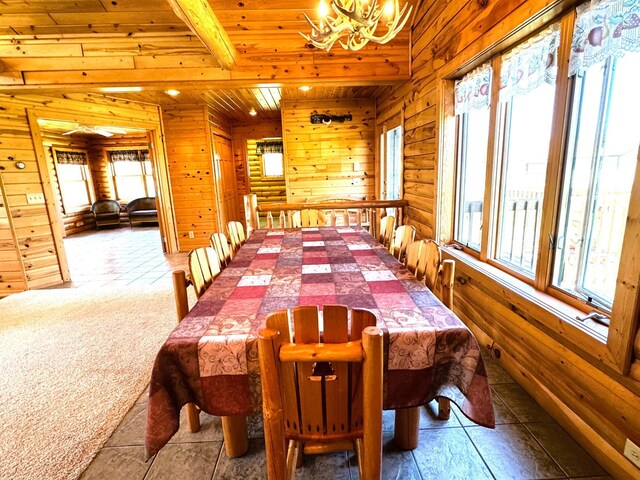 35918 410th Ave SE, Queen Twp, MN 56542 - carpeted dining area with a chandelier, wood ceiling with exposed beams, and wooden walls