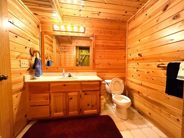 35918 410th Ave SE, Queen Twp, MN 56542 - bathroom featuring wood ceiling, wood walls, vanity, toilet, and tile patterned flooring