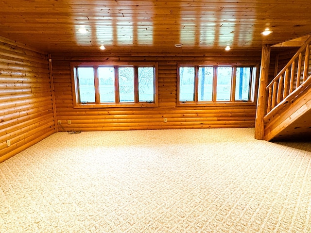 35918 410th Ave SE, Queen Twp, MN 56542 - unfurnished living room with log walls, wooden ceiling, stairs, carpet, and recessed lighting