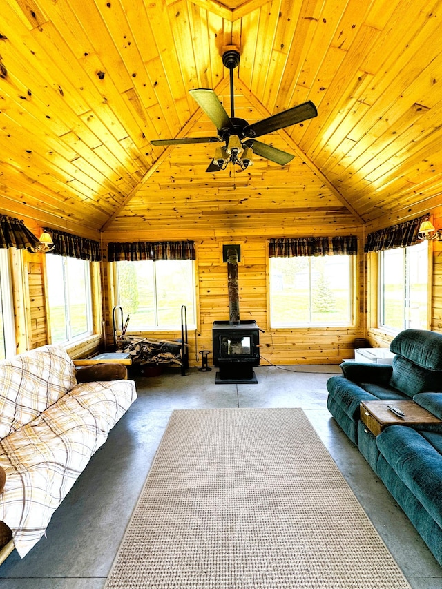 35918 410th Ave SE, Queen Twp, MN 56542 - living room with vaulted ceiling, a wood stove, wood walls, wooden ceiling, and ceiling fan