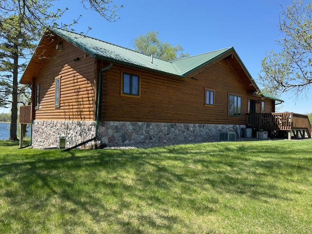 35918 410th Ave SE, Queen Twp, MN 56542 - view of side of home with a lawn, cooling unit, a deck, and metal roof