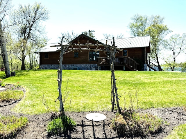 35918 410th Ave SE, Queen Twp, MN 56542 - back of house featuring stairs, a lawn, and metal roof
