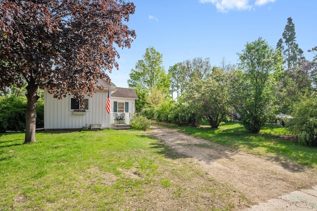 view of front of house featuring board and batten siding and a front lawn