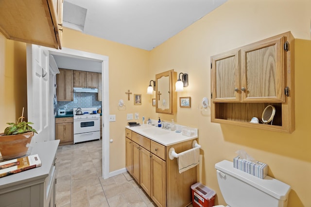 bathroom with decorative backsplash, toilet, vanity, and tile patterned floors