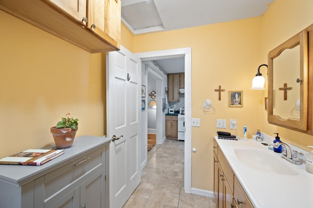 bathroom with vanity, baseboards, and tile patterned flooring