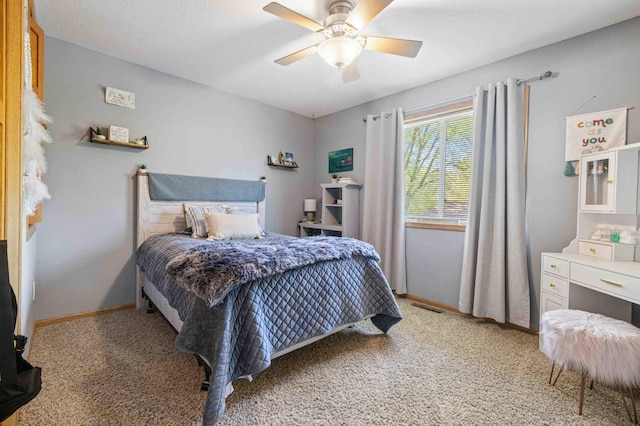 bedroom with light carpet, ceiling fan, and baseboards