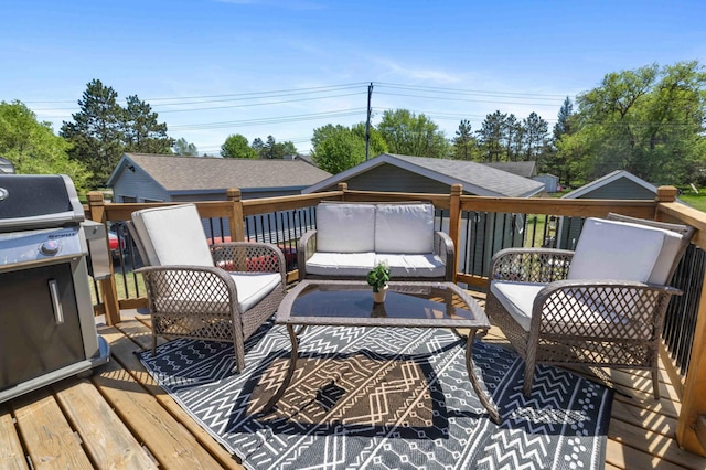 wooden deck with an outdoor hangout area and area for grilling