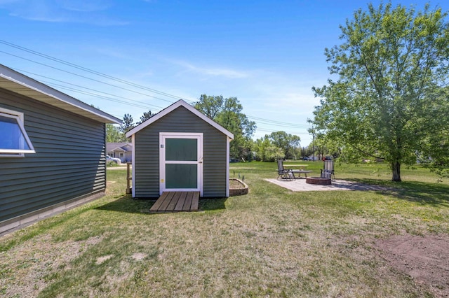 view of shed with an outdoor fire pit