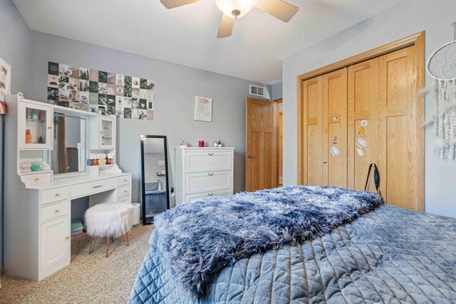 bedroom featuring carpet floors, a closet, and a ceiling fan