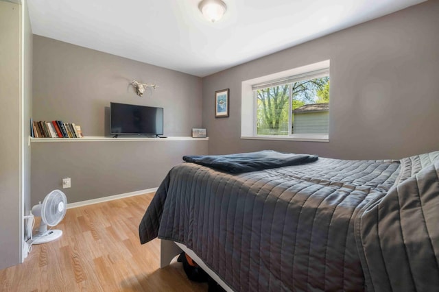 bedroom featuring wood finished floors and baseboards