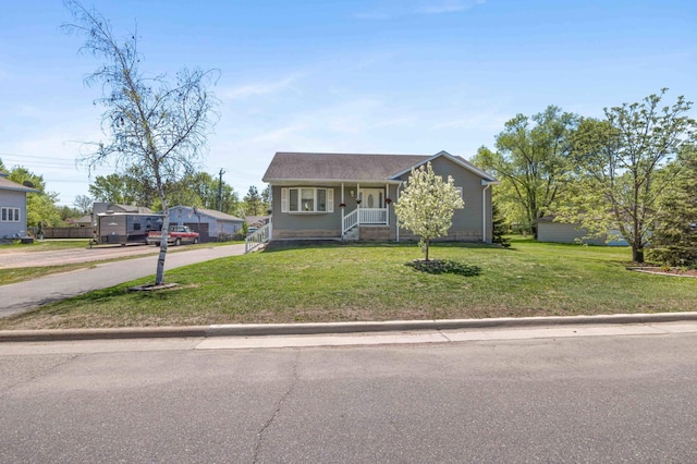 view of front of property featuring a porch, a front lawn, and driveway