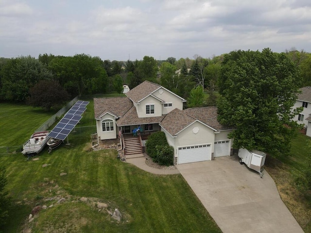 9386 Jennifer Ct, Chisago Lake Twp, MN 55013 - view of front facade with an attached garage, driveway, a front yard, and ground mounted solar panels