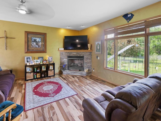 9386 Jennifer Ct, Chisago Lake Twp, MN 55013 - living area with a stone fireplace, wood finished floors, and baseboards