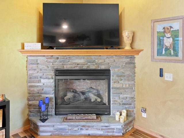 9386 Jennifer Ct, Chisago Lake Twp, MN 55013 - detailed view of a fireplace, wood finished floors, and baseboards