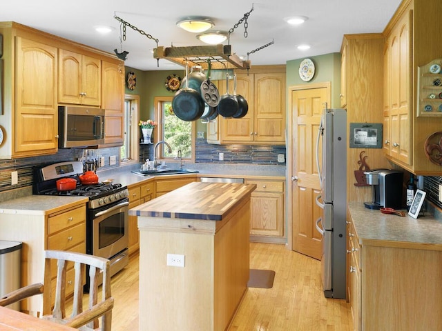 9386 Jennifer Ct, Chisago Lake Twp, MN 55013 - kitchen with stainless steel appliances, wood counters, a sink, a center island, and decorative backsplash