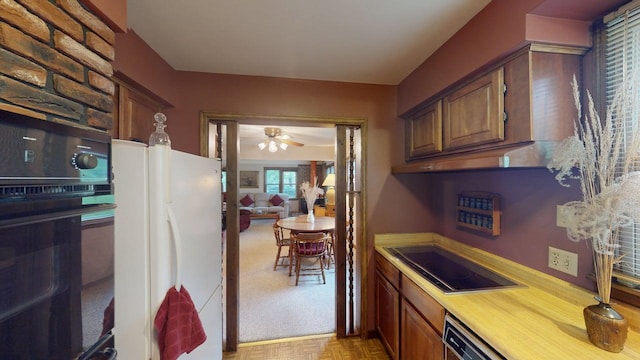 2559 Westview Ter, Hopkins, MN 55305 - kitchen with black appliances, brown cabinetry, light countertops, and a ceiling fan