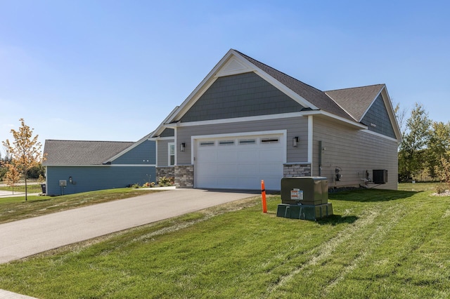 20105 Glenbrook Path, Lakeville, MN 55044 - view of side of home featuring an attached garage, a lawn, concrete driveway, stone siding, and central AC