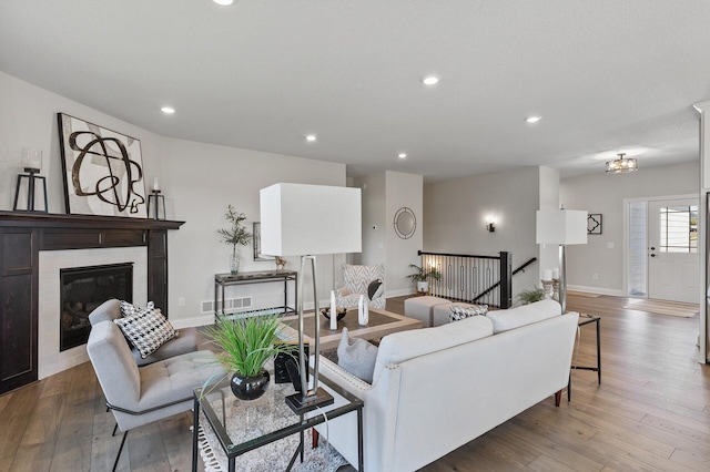 20105 Glenbrook Path, Lakeville, MN 55044 - living area featuring hardwood / wood-style flooring, baseboards, recessed lighting, and a glass covered fireplace