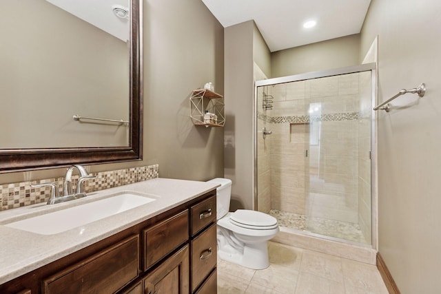 12187 Dunkirk St NE, Blaine, MN 55449 - full bathroom with toilet, vanity, a stall shower, and tile patterned flooring