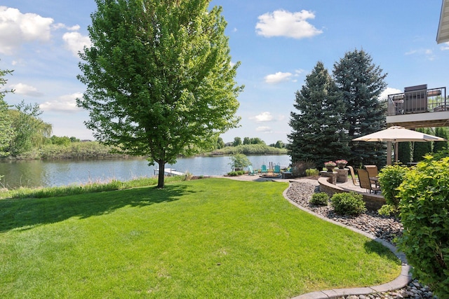12187 Dunkirk St NE, Blaine, MN 55449 - view of green lawn featuring a water view and a patio area