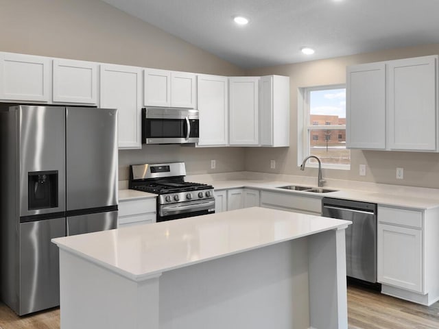 6718 Granby St, North Branch, MN 55056 - kitchen with stainless steel appliances, a sink, lofted ceiling, light countertops, and a center island
