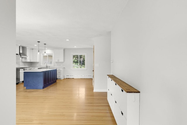 1409 Smith Ave S, West Saint Paul, MN 55118 - kitchen with light wood finished floors, light countertops, recessed lighting, white cabinets, and pendant lighting