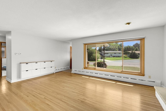 1409 Smith Ave S, West Saint Paul, MN 55118 - unfurnished living room with wood finished floors and a baseboard heating unit