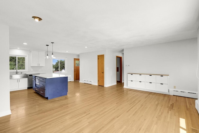 1409 Smith Ave S, West Saint Paul, MN 55118 - kitchen featuring white cabinets, light countertops, light wood-type flooring, recessed lighting, and open floor plan