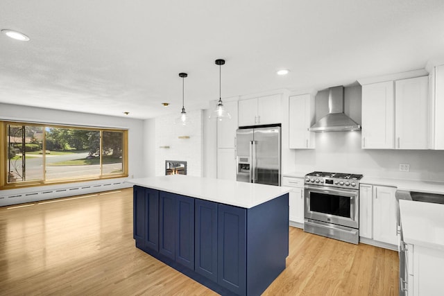 1409 Smith Ave S, West Saint Paul, MN 55118 - kitchen with stainless steel appliances, wall chimney range hood, a kitchen island, recessed lighting, and light wood-style floors