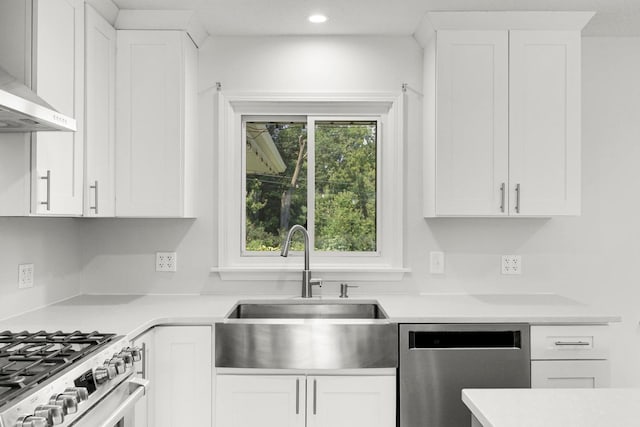 1409 Smith Ave S, West Saint Paul, MN 55118 - kitchen featuring appliances with stainless steel finishes, wall chimney exhaust hood, light countertops, white cabinets, and recessed lighting