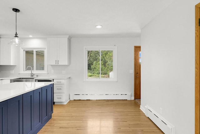 1409 Smith Ave S, West Saint Paul, MN 55118 - kitchen with a baseboard heating unit, light countertops, white cabinetry, and recessed lighting
