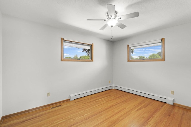 1409 Smith Ave S, West Saint Paul, MN 55118 - unfurnished room with healthy amount of natural light, wood finished floors, and a ceiling fan