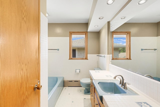 1409 Smith Ave S, West Saint Paul, MN 55118 - full bathroom featuring tile walls, healthy amount of natural light, vanity, a baseboard heating unit, and recessed lighting