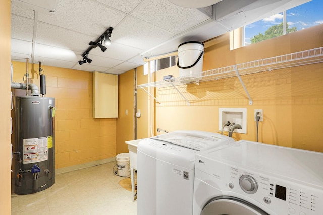 1409 Smith Ave S, West Saint Paul, MN 55118 - laundry room with washer and clothes dryer, rail lighting, concrete block wall, gas water heater, and tile patterned floors