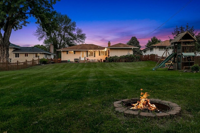 1409 Smith Ave S, West Saint Paul, MN 55118 - back of house featuring a playground, a chimney, a fenced backyard, and an outdoor fire pit