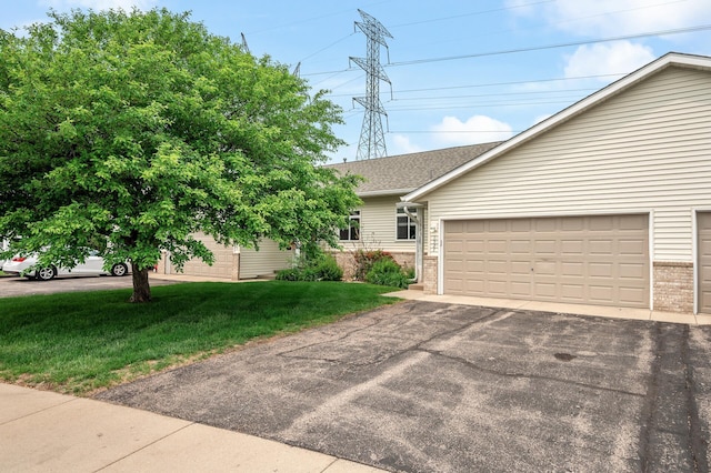 1527 Dublin Ct, Shakopee, MN 55379 - view of front of house with brick siding, asphalt driveway, a shingled roof, and a front lawn