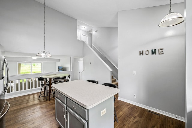 1527 Dublin Ct, Shakopee, MN 55379 - kitchen with gray cabinetry, light countertops, a kitchen island, pendant lighting, and a kitchen breakfast bar