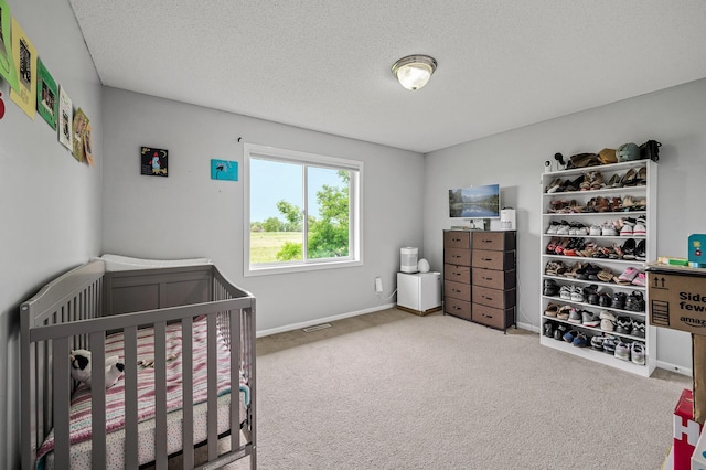 1527 Dublin Ct, Shakopee, MN 55379 - carpeted bedroom with a crib, a textured ceiling, and baseboards