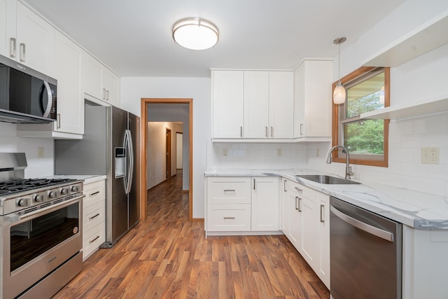 328 County Road B2 W, Roseville, MN 55113 - kitchen with stainless steel appliances, a sink, tasteful backsplash, light wood finished floors, and white cabinets