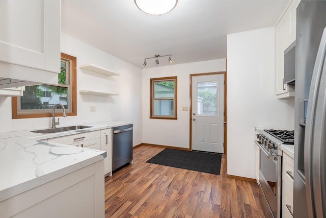 328 County Road B2 W, Roseville, MN 55113 - kitchen with a sink, appliances with stainless steel finishes, white cabinetry, and decorative backsplash