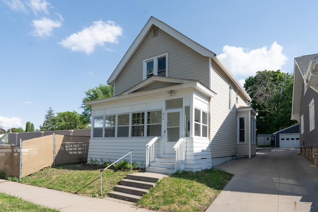 410 Baker St W, Saint Paul, MN 55107 - traditional-style house featuring fence, a detached garage, and an outdoor structure