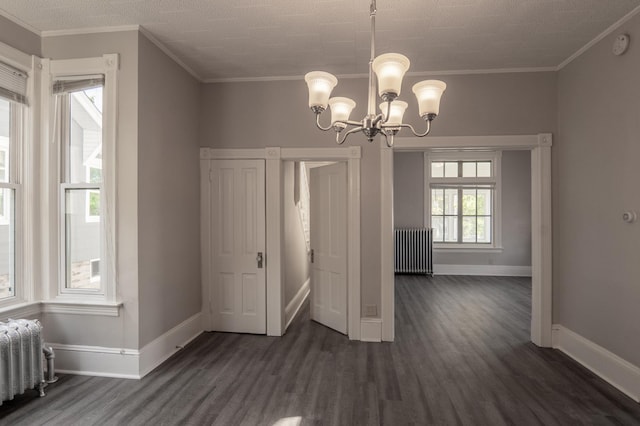 410 Baker St W, Saint Paul, MN 55107 - unfurnished dining area featuring radiator heating unit, dark wood finished floors, baseboards, and crown molding