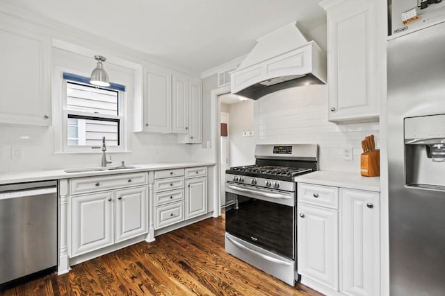 5629 35th Ave S, Minneapolis, MN 55417 - kitchen featuring appliances with stainless steel finishes, premium range hood, a sink, white cabinets, and ornamental molding